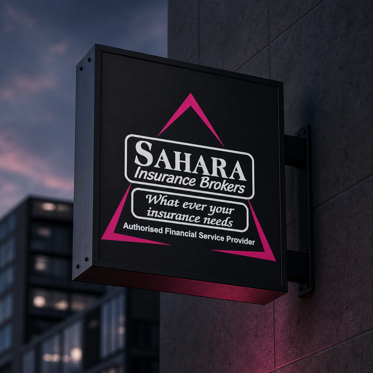 Sahara Insurance Brokers projecting sign on a charcoal building at dusk